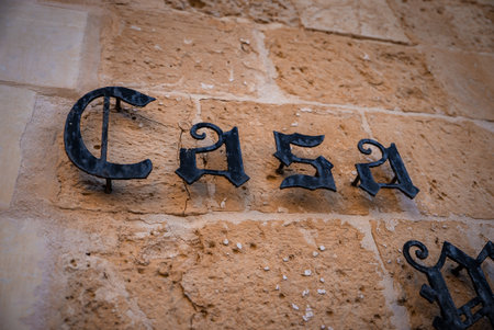 Wrought iron Casa sign on limestone wall in Mdina, Maltaの写真素材