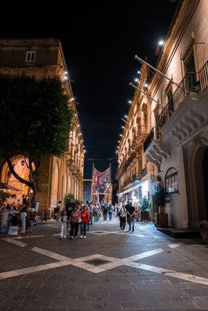 Nighttime pedestrians on Baroque street in Valletta, Maltaの写真素材