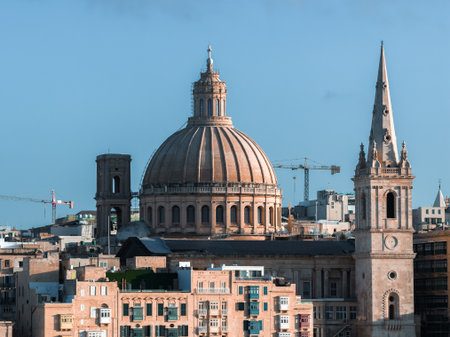 Valletta skyline with basilica dome and cathedral spire in daylightの写真素材
