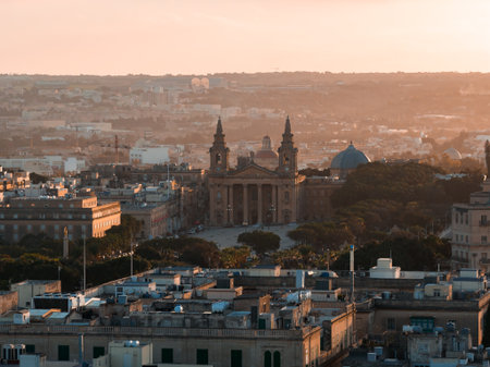 Aerial golden hour over Valletta, Malta, centered on baroque spiresの写真素材