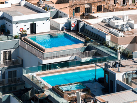 Aerial rooftop pools and terraces in Mellieha Malta at middayの写真素材