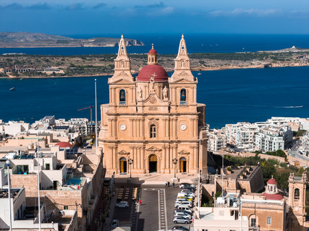 Aerial view of Mellieha Parish Church above Mellieha and bayの写真素材