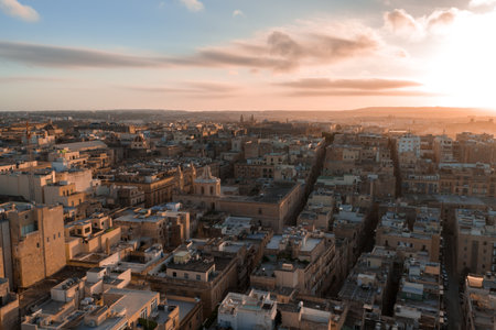 Aerial golden hour view of Valletta rooftops, domes, and harborsの写真素材