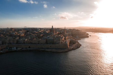 Aerial sunset over Valletta, Malta, walled peninsula and harborsの写真素材