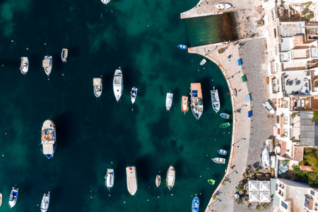 Aerial waterfront curve in Sliema, Malta with boats and stone quay
