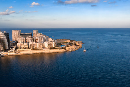 Aerial sunset over Valletta peninsula, Malta, with boats and bastionsの写真素材