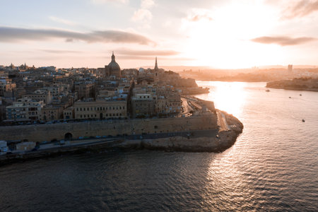 Aerial sunset over Valletta, Malta, Grand Harbour and bastions