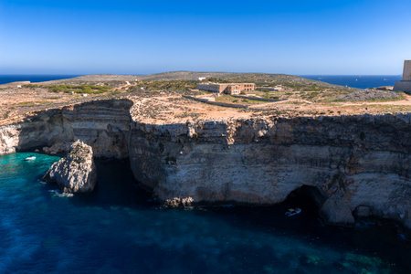 Aerial view of Comino cliffs, sea cave, and St Marys Batteryの写真素材