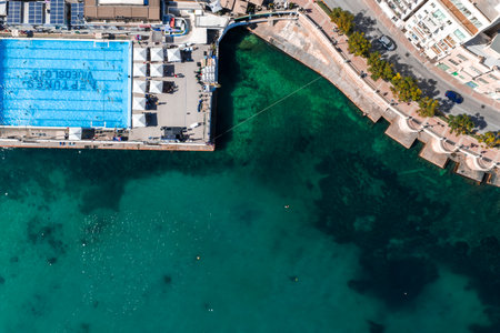 Aerial view of Sliema seafront pool beside Mediterranean watersの写真素材