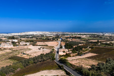 Aerial view of Mdina outskirts with fields and road toward Maltaの写真素材