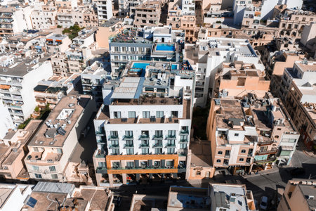 Aerial midday view of Mellieha urban quarter with rooftop poolsの写真素材