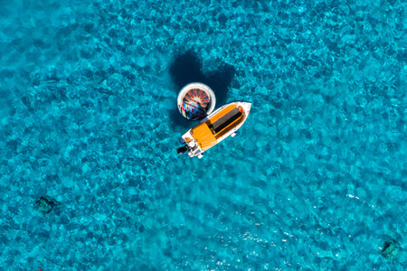 Aerial view of motorboat and circular float in Blue Lagoon, Maltaの写真素材