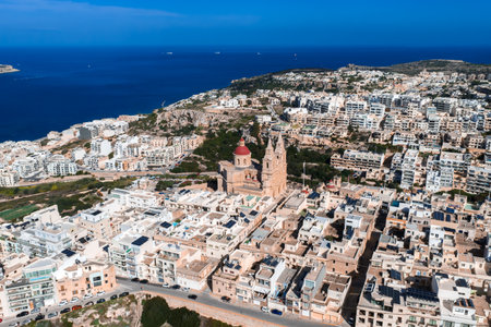 Aerial panorama of Mellieha, Malta with red domed parish churchの写真素材