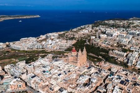 Aerial panorama of Mellieha, Malta, with red domed sanctuary and bayの写真素材
