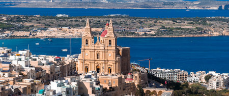 Aerial panorama of Mellieha with parish church and Mellieha Bayの写真素材