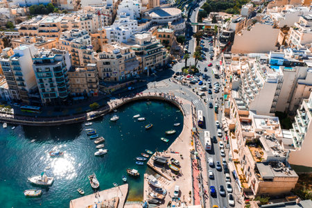 Aerial midday view of Sliema Malta bay with boats and promenadeの写真素材