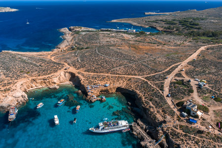 Aerial view of Blue Lagoon, Comino Island, Malta with boats and caveの写真素材