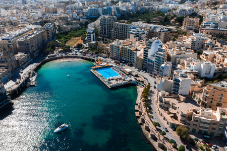 Aerial panorama of Sliema waterfront with lido pool and inletの写真素材