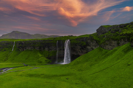 Seljalandsfoss and adjacent cascade in Iceland at evening lightの写真素材
