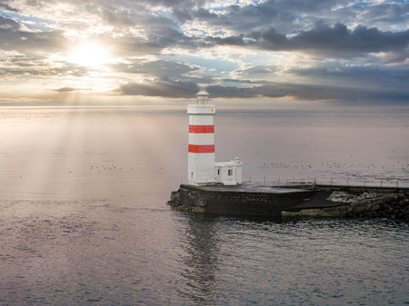 Aerial view of Grotta Lighthouse on a rocky breakwater in Icelandの写真素材