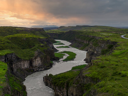 Aerial view of Sigoldugljufur Canyon, basalt walls and river at sunsetの写真素材