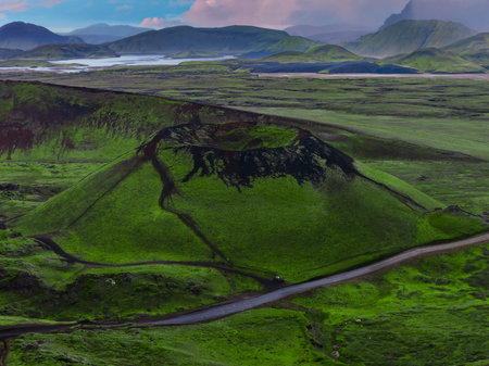 Aerial volcanic crater and winding road in Icelands Highlandsの写真素材