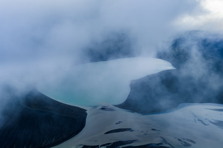 Aerial view of a pale crater lake and dark lava slopes in Icelandの写真素材