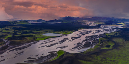 Aerial braided river over mossy highlands and lava fields in Icelandの写真素材