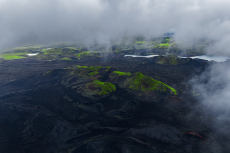 Aerial volcanic highlands near Landmannalaugar, dark lava and mossの写真素材