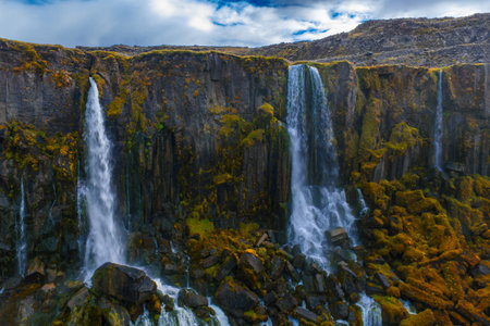Aerial view of basalt cliffs and cascades in Icelandic Highlands gorge
