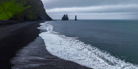 Reynisfjara Beach black sands and Reynisdrangar stacks in Iceland
