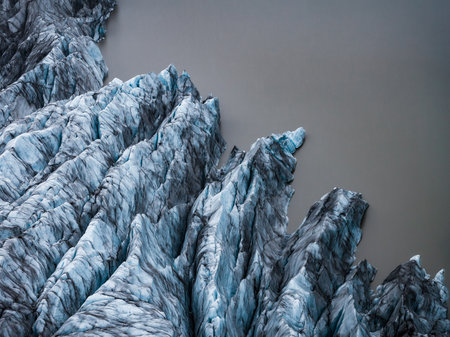 Aerial view of Iceland glacier tongues meeting a milky lagoonの写真素材