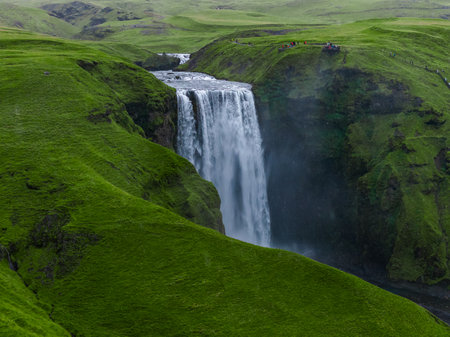 Skogafoss waterfall drops into a misty gorge in southern Icelandの写真素材