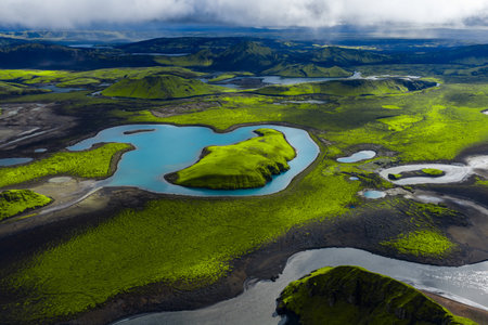 Aerial emerald island on turquoise lake in Iceland highlands