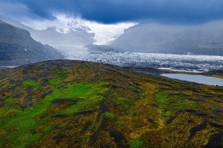 Mossy lava plain and glacier tongue in Vatnajokull National Parkの写真素材