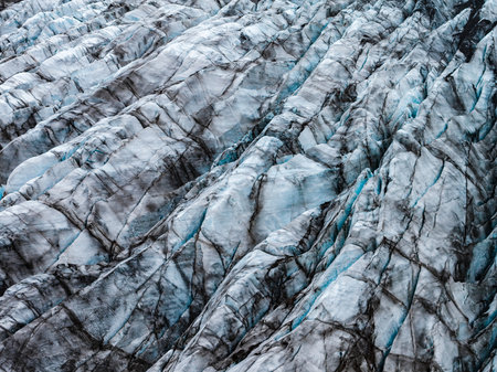 Aerial close up of blue glacier crevasses with volcanic ash bands, Icelandの写真素材