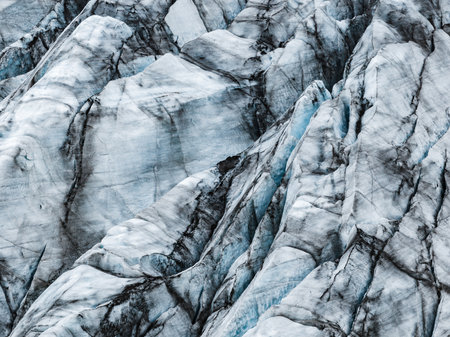 Icelandic glacier close up with ash streaked ridges and crevassesの写真素材