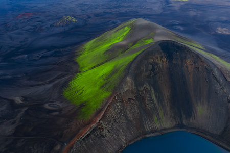 Aerial volcanic crater with turquoise lake and moss in Icelandの写真素材