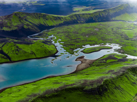 Aerial glacial river meets turquoise lake in Iceland Highlandsの写真素材