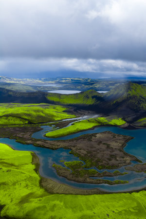 Aerial rivers and lagoons over moss green lava fields in Icelandの写真素材