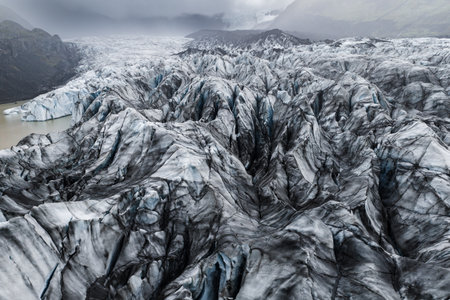 Aerial view of crevassed ash streaked ice on Icelandic glacierの写真素材