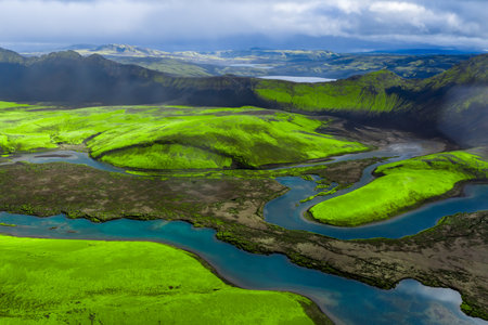 Aerial river over neon moss and black sands in Iceland highlandsの写真素材