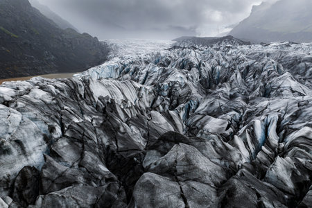Aerial view of icy crevasses and ash on Vatnajokull glacier fieldの写真素材