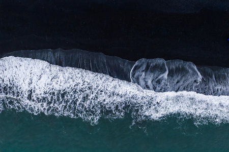 Aerial overhead of waves on Vik black sand beach, South Coast Icelandの写真素材