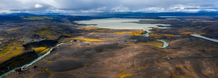 Aerial panorama of Iceland highlands, braided glacial river to lake
