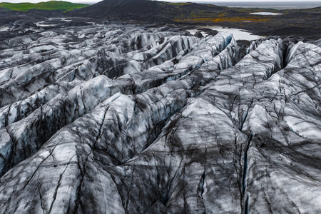 Aerial view of ash streaked glacier and lava fields in Icelandの写真素材