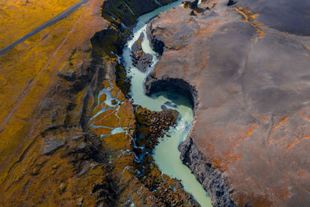 Aerial S curve glacial river through volcanic plains near Sigoldugljufurの写真素材