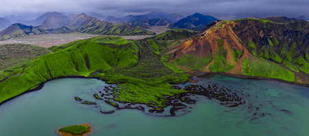 Aerial panorama of Landmannalaugar lake, sandbars, and rhyolite slopesの写真素材