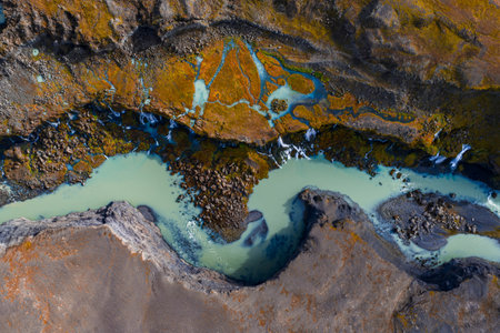 Aerial view of glacial river over volcanic terrain in Iceland