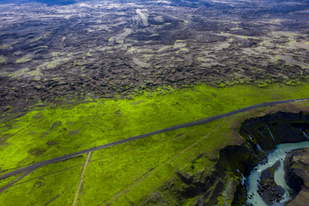 Aerial road divides moss plain and lava field near Landmannalaugar, Icelandの写真素材